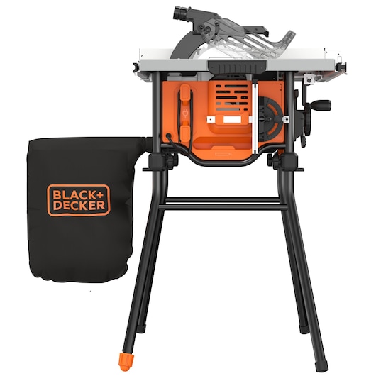 A BLACK+DECKER table saw with an orange and black design, mounted on a black metal stand. The saw includes a dust collection bag attached to the left side with the BLACK+DECKER logo, and adjustment levers and a blade guard visible on top.