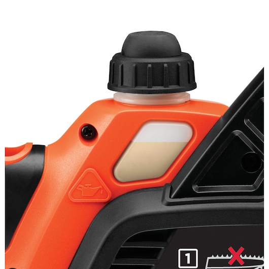 Close-up of the oil tank and cap on a BLACK+DECKER chainsaw, showing the orange and black body with a transparent oil level indicator.